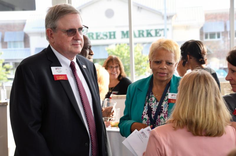 Community Back Delaware President Jack Riddle mingles with the large crowd of customers attending a May 25 open house.